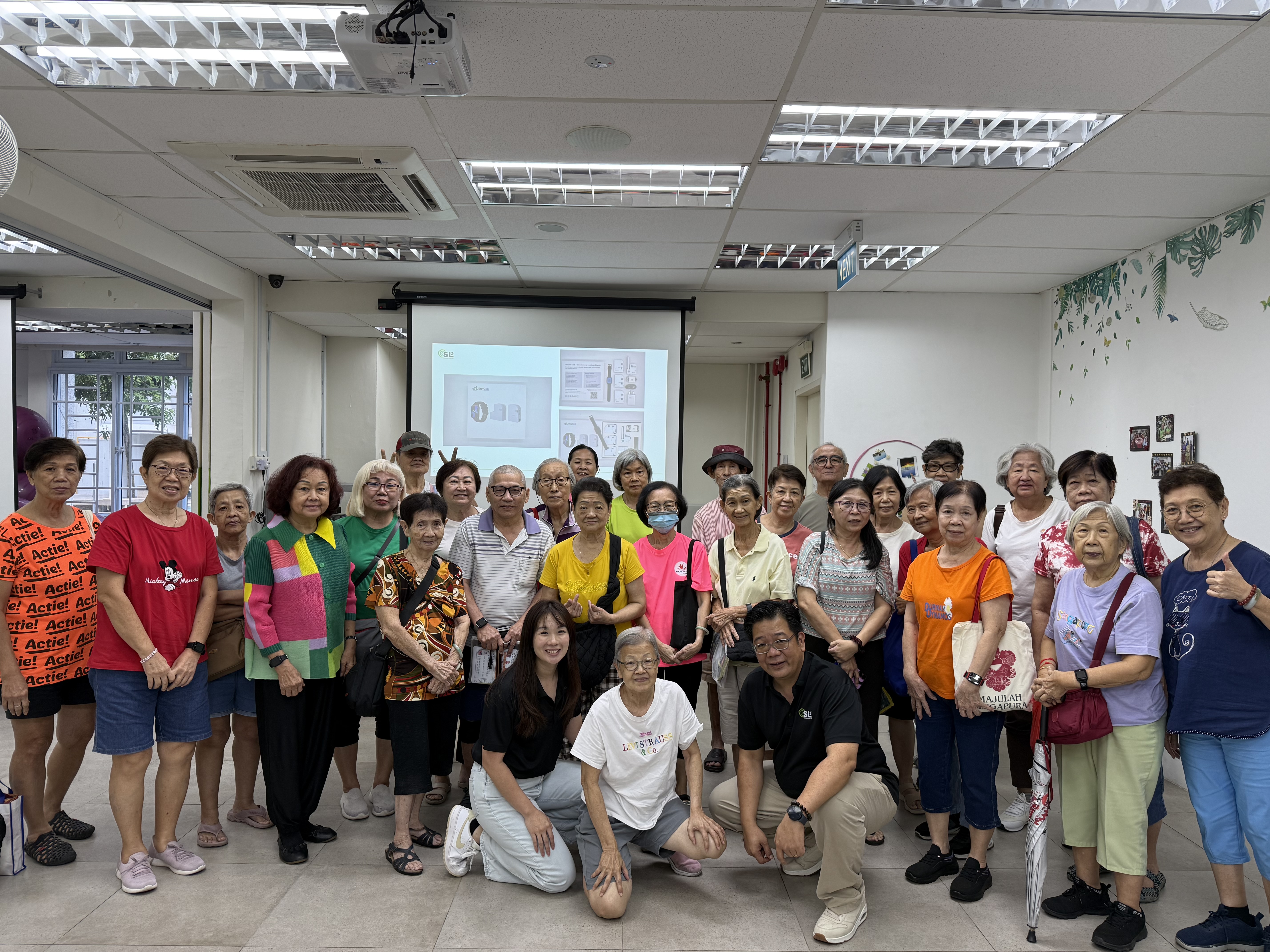 SL2 team members with seniors from Lions Befrienders after a heat health talk on indoor heat, early signs of heat stress, and simple ways to stay cool at home.